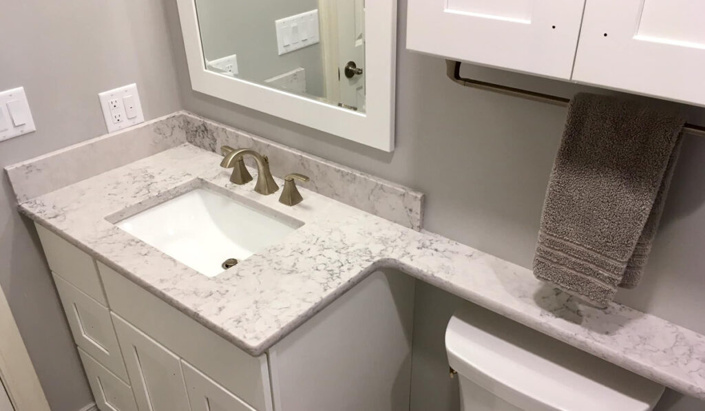 small bathroom sink with white marble surface