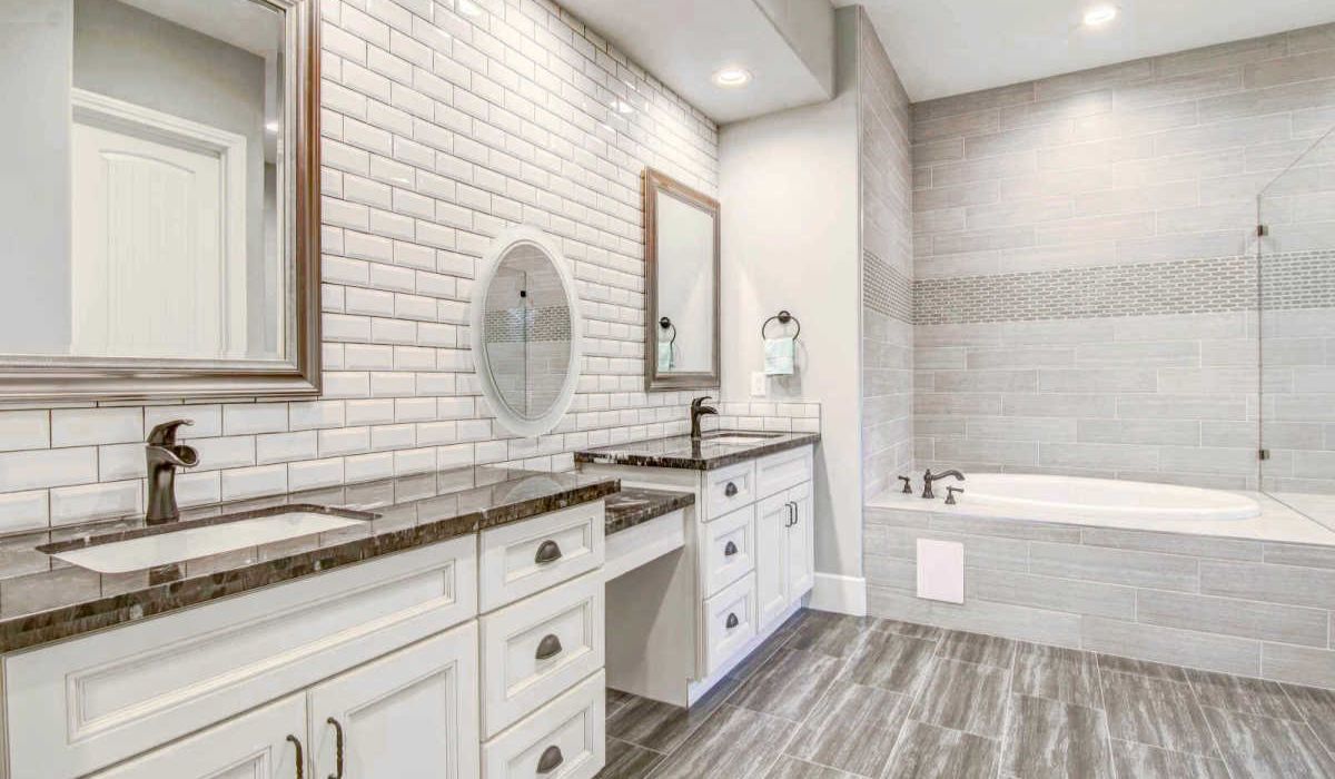 a bathroom with two sinks and a walk-in shower